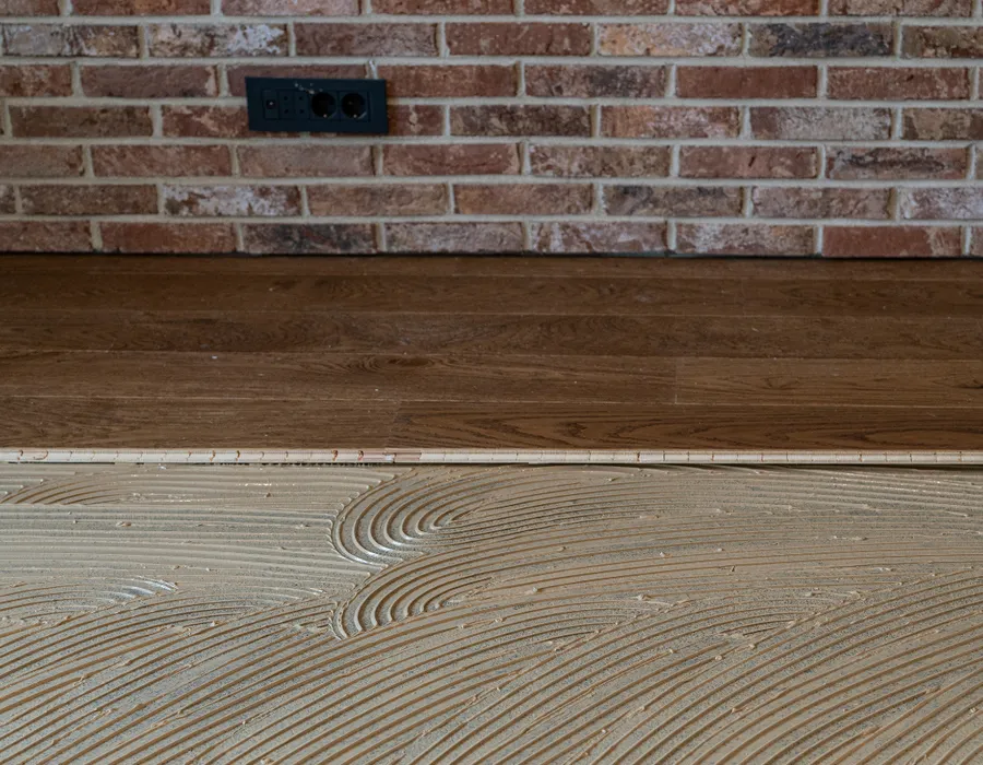 APW installer fitting luxury vinyl plank flooring in a central NC home